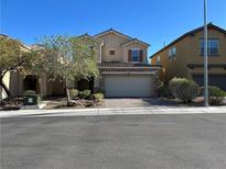 Charming two-story home featuring stucco siding, a tile roof, a two-car garage, and manicured landscaping at 8977 Melridge Rd, Las Vegas, NV 89148