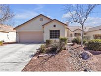 Charming single-story home features a neutral exterior, a two-car garage and manicured landscaping at 9562 Collinsleap Ct, Las Vegas, NV 89123