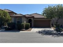 Charming single-story home featuring a well-manicured front yard and a two-car garage at 10590 Natural Bridge St, Las Vegas, NV 89179