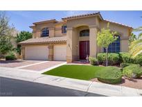Charming two-story home with a well-manicured lawn, a tile roof, and a three-car garage at 1421 Via Savona Dr, Henderson, NV 89052