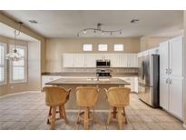 Spacious kitchen featuring a central island, stainless steel appliances, and tile flooring at 1574 Livingston Dr, Henderson, NV 89012