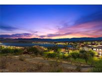 Scenic twilight view of Lake Las Vegas surrounded by trees and homes, creating a serene and picturesque landscape at 20 Via Visione # 105, Henderson, NV 89011