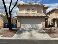A cozy two-story house with a two-car garage and a red tile roof at 2130 Dragonslayer Ave, Las Vegas, NV 89183