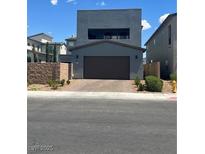 Contemporary two-story home featuring a sleek gray facade and a spacious two-car garage and clean landscaping at 2650 Skylark Trail St, Henderson, NV 89044
