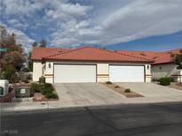 Charming single-story home featuring a red tile roof and attached two-car garage at 2679 Magic Moon Ln, Las Vegas, NV 89146