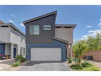 Modern two-story home featuring a two-car garage, contemporary siding, and well-maintained landscaping at 3707 Paseo De Paz Ave, Las Vegas, NV 89115