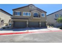 Inviting home featuring a three-car garage, neutral exterior, balcony, and well-kept landscaping at 4645 Fuchsia Nights Ave # 103, North Las Vegas, NV 89084