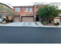Two story home with a three car garage and mature landscaping in a residential neighborhood at 530 Calahonda Ct, Las Vegas, NV 89138