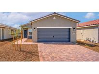 Charming single-story home featuring desert landscaping and a brick paved driveway to the attached two-car garage at 6743 Violet Cascade Ave, Las Vegas, NV 89156