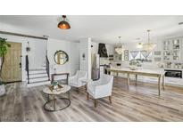 Inviting living room boasts an open floorplan, wood floors, modern decor, and seamless flow to the kitchen at 7566 Hope Valley St, Las Vegas, NV 89139