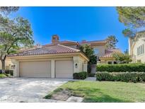 Charming home features a two-car garage, red tile roof, and mature landscaping at 8121 Castle Pines Ave, Las Vegas, NV 89113