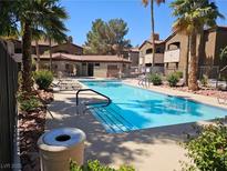 Resort-style pool with lounge chairs and lush landscaping at 9000 Las Vegas Blvd # 2061, Las Vegas, NV 89123