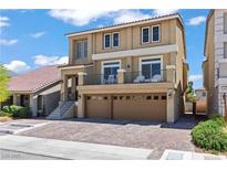 Two-story home showcasing a private balcony, two-car garage, and tiled roof at 9742 Toad Hollow St, Las Vegas, NV 89141