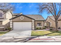 Charming single-story home with a well-manicured lawn, a two-car garage, and beautiful landscaping at 10205 Birch Bluff Ln, Las Vegas, NV 89145