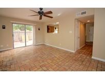 Bright living room with brick flooring and sliding glass doors to the backyard at 1467 Hialeah Dr # C, Las Vegas, NV 89119