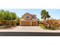 Charming two-story home with a two-car garage, well-manicured landscaping, and a classic Southwest design at 215 Sunlight Peak St, Henderson, NV 89012