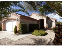 Charming single-story home featuring a well-maintained front yard with desert landscaping and mature trees at 2156 Eagle Sticks Dr, Henderson, NV 89012