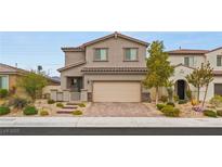 Charming two-story home with desert landscaping, brick driveway, and a neutral color scheme at 2624 Stanhurst Ave, North Las Vegas, NV 89081