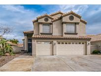 Charming two-story home with a tile roof and spacious two-car garage, complemented by desert landscaping at 271 Sunshine Springs Ct, Henderson, NV 89014