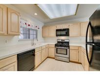 Well-lit kitchen featuring stainless steel appliances and light wood cabinets at 2851 S Valley View Blvd # 1161, Las Vegas, NV 89102