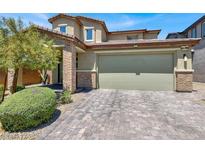 Charming two-story home with a two-car garage and an inviting brick-accented entrance at 3136 Mossfield Ave, Henderson, NV 89052
