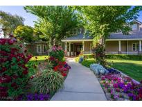 Charming home with lush landscaping, vibrant flowers, and a welcoming walkway at 330 Rancho Cir, Las Vegas, NV 89107