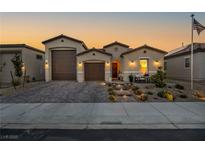 Charming single-story home features a two-car garage and meticulously landscaped front yard, creating a welcoming curb appeal at 6325 Gambetta St, Las Vegas, NV 89115