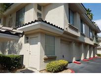 Charming townhome with stucco exterior, private entrance, and attached garage in a well-maintained community at 7185 S Durango Dr # 213, Las Vegas, NV 89113