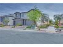 Charming two-story home with desert landscaping, brick accents, and a three-car garage at 764 Aurora Vale Pl, Henderson, NV 89011