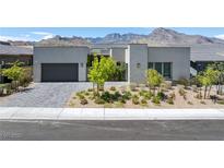 Contemporary home featuring modern architectural elements, a two-car garage, and desert landscaping at 787 Willits St, Las Vegas, NV 89138