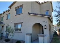 Charming two-story home featuring a welcoming arched entryway and neutral stucco finish at 806 Star Estates Ave, North Las Vegas, NV 89086