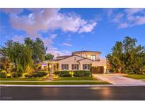 Stunning two-story home with a well-manicured lawn, lush landscaping, and a private garage at 100 S Royal Ascot Dr, Las Vegas, NV 89144