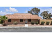 Charming single-story home featuring a traditional red tile roof, desert landscaping, and a well-maintained exterior at 2504 Paradise Village Way, Las Vegas, NV 89120