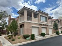 Charming two-story condo boasts a private balcony and attached one-car garage at 251 S Green Valley Pkwy # 721, Henderson, NV 89012