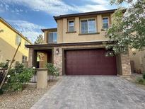 Charming two-story home with brick accents, a wide driveway, and an attached two-car garage at 2947 Caxton Grove Dr, Henderson, NV 89052