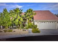 Charming single-story home with desert landscaping, mature palms, and a two-car garage at 390 Rushing Creek Ct, Henderson, NV 89014