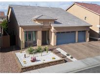 Charming single-Gathering home features a well-manicured desert landscape, with a three car garage and tile roof at 5850 Rockway Glen Ave, Las Vegas, NV 89141