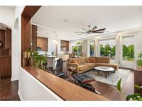 Bright living room featuring hardwood floors, modern furnishings, and backyard view at 5850 Rockway Glen Ave, Las Vegas, NV 89141