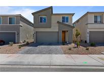 Charming two-story home featuring desert landscaping, brick paved driveway, and an attached two car garage at 5937 W Frias Ave, Las Vegas, NV 89141