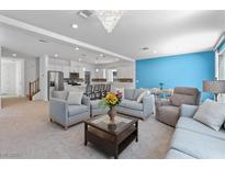 Spacious living room featuring an open floor plan with modern decor and a stylish chandelier at 5937 W Frias Ave, Las Vegas, NV 89141