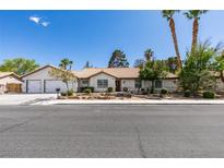 Charming single-story home featuring a well-maintained yard and two-car garage in a serene neighborhood at 6517 W Brooks Ave, Las Vegas, NV 89108