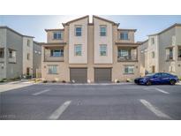 Modern townhome exterior with balconies and attached two-car garage, showcasing contemporary design at 7003 Crimson Shadow St, North Las Vegas, NV 89086