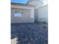 Charming home with a brick paved driveway and neutral colored garage, decorated with balloons and a welcome home banner at 740 Omaggio Pl, Henderson, NV 89011