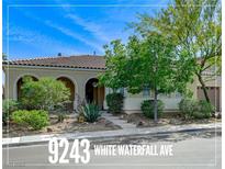 Charming single-story home featuring desert landscaping, a tile roof, and an attached two-car garage at 9243 White Waterfall Ave, Las Vegas, NV 89149