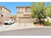 Two-story home with neutral toned exterior, driveway, two car garage, and mature landscaping at 9412 Jewel Lake Ave, Las Vegas, NV 89166