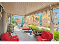 Cozy covered patio with comfortable seating and colorful garden decor, perfect for outdoor relaxation and entertaining at 9412 Jewel Lake Ave, Las Vegas, NV 89166