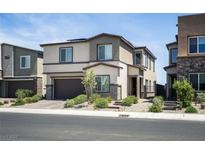 Contemporary two-story home with neutral stucco, stylish landscaping, and an attached two-car garage at 9732 Abel Cliff St, Las Vegas, NV 89143