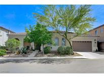 Charming single-story home with a well-manicured front yard and two-car garage under a brilliant, sunny sky at , Las Vegas, NV 89149