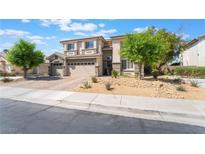 A two-story home featuring a three-car garage and well-maintained landscaping at 1291 Rolling Sunset St, Henderson, NV 89052