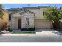 Inviting two-story home with stone accents, manicured landscaping, and a spacious two-car garage at 137 Coronation Ave, Las Vegas, NV 89123